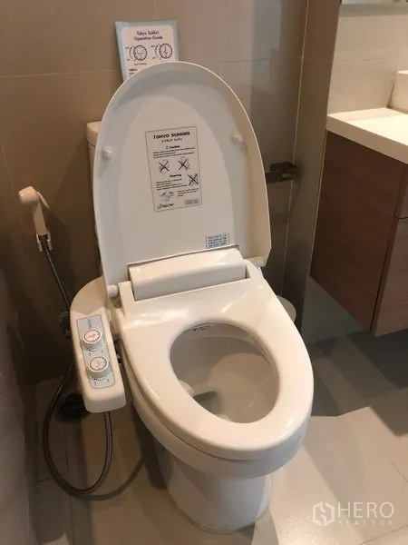 Condominium for rent in Bangkok - Modern bathroom featuring a smart bidet toilet and floating vanity.