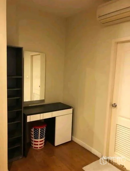 Townhouse for rent in Phra Khanong, Bangkok - Dressing corner with vanity, mirror, shelving unit and air conditioner.