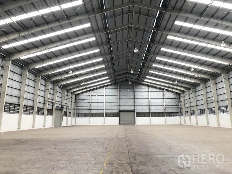 Warehouse for rent in Phra Nakhon Si Ayutthaya - Open storage hall showing gable roof, bright LED lighting and wide, unobstructed floor space.