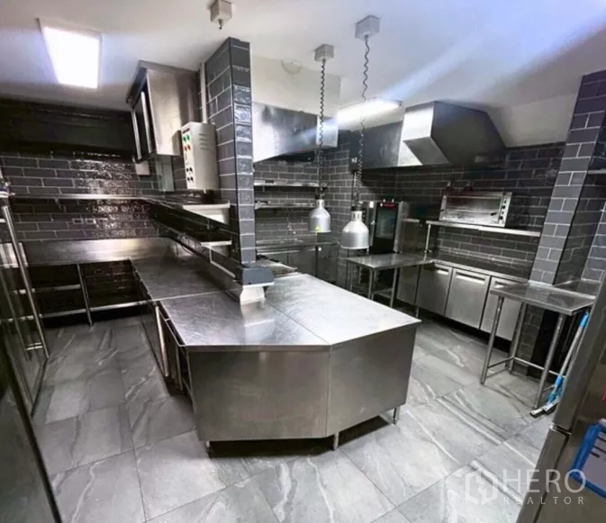 Retail Space for rent in Yan Nawa, Bangkok - Stainless-steel professional kitchen with commercial hoods, counters and pendant heat lamps.