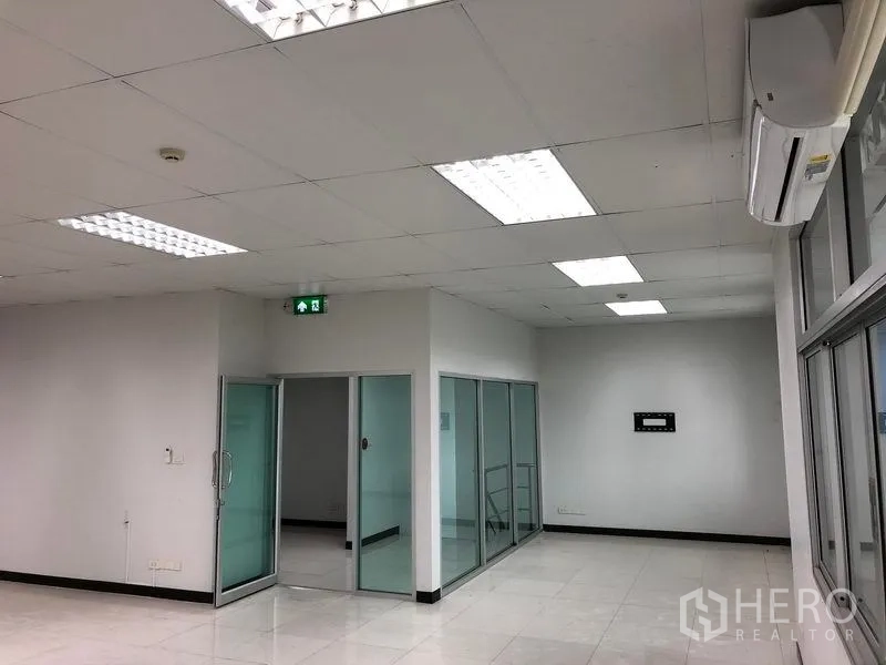 Warehouse for rent in Bang Phli, Samut Prakan - Modern office space with glass partitions, tiled flooring, and air-conditioning inside the warehouse.