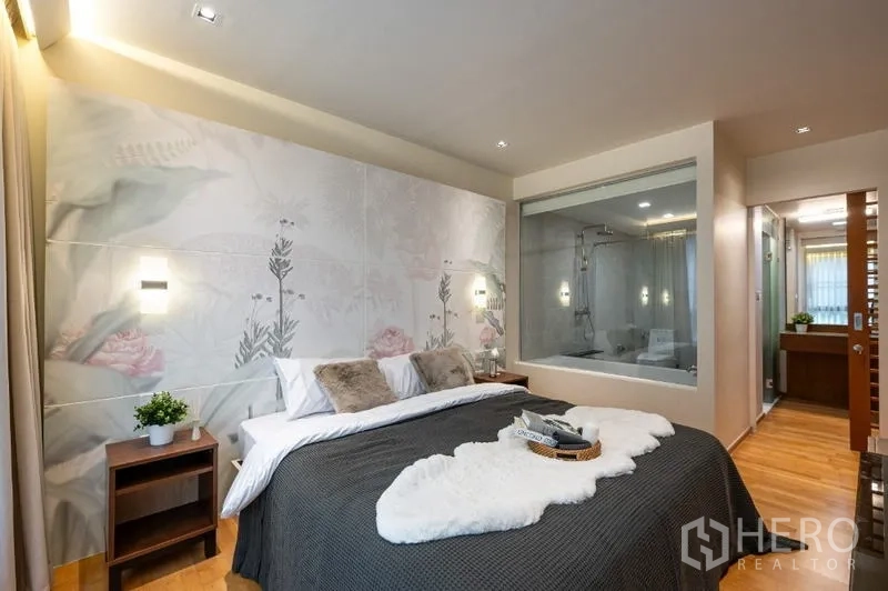 Condominium for sale - Master bedroom with floral wall, glass viewing panel to bath and corridor vanity.