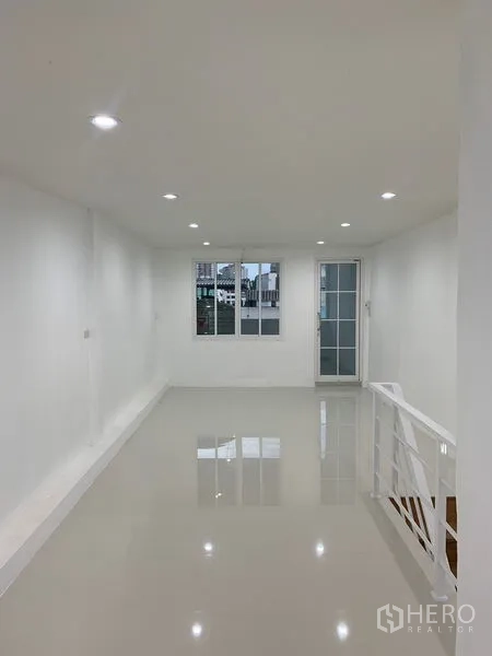Townhouse for sale in Yan Nawa, Bangkok - Bright open-plan living area with glossy floors and recessed lighting.