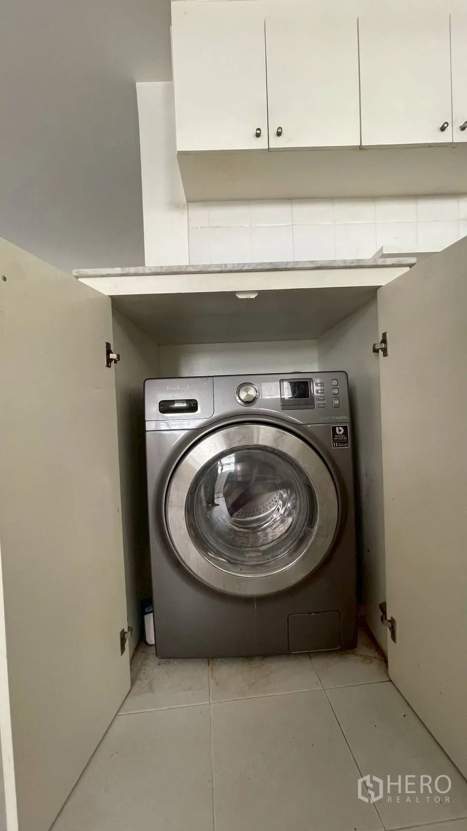 Condominium for sale in Wang Thonglang, Bangkok - Washer–dryer neatly integrated in a kitchen cabinet.