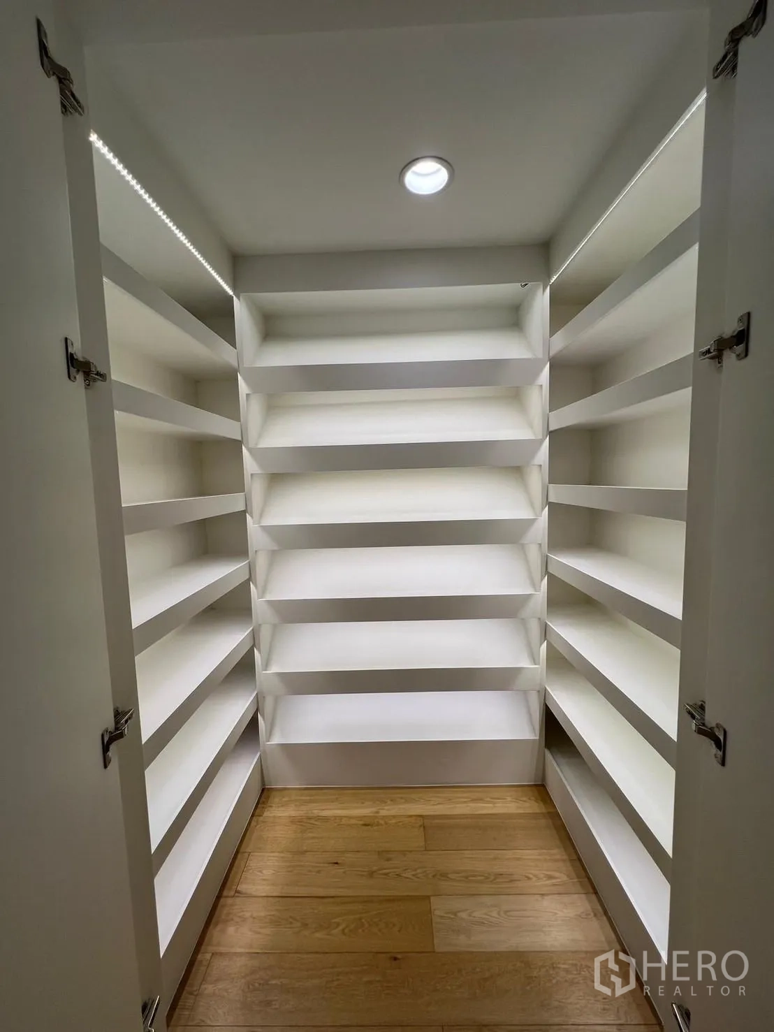Condominium for rent or sale in Sathon, Bangkok - Walk-in storage room with built-in white shelving and wood flooring.