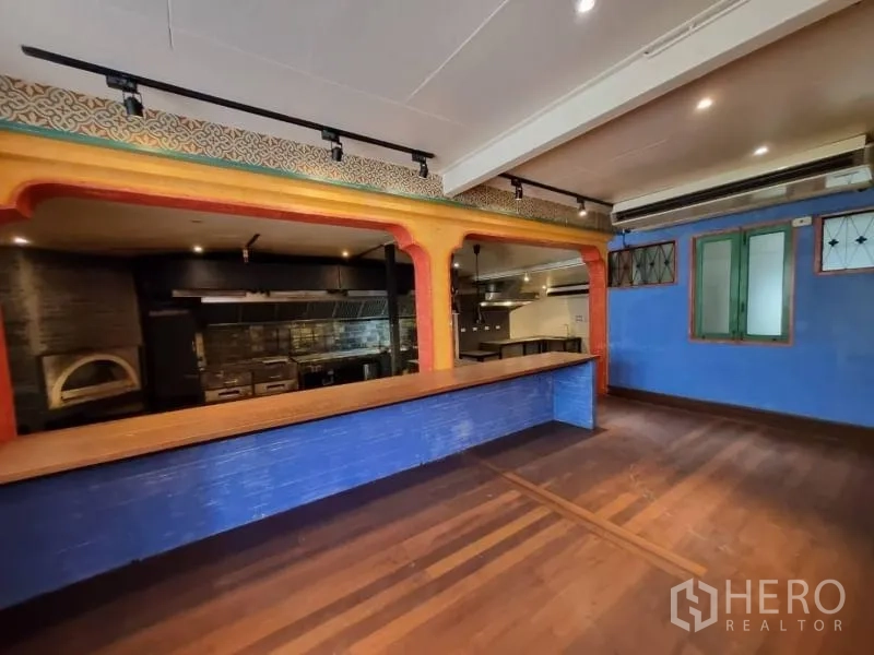 Detached House for rent in Khlong Toei, Bangkok - Serving bar opening to the kitchen, wood flooring and decorative archways.