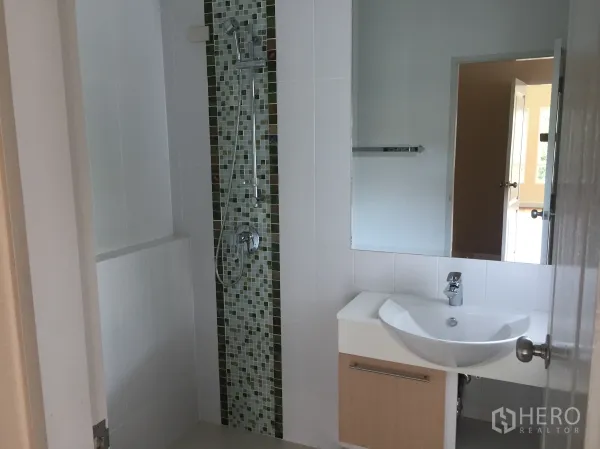 Detached House for sale in Saphan Sung, Bangkok - Modern bathroom featuring a mosaic-tile shower and sleek white vanity.