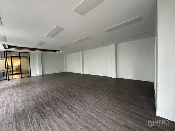 Retail Space for rent in Bang Rak, Bangkok - Large retail area with ceiling light panels and glass partition doors.
