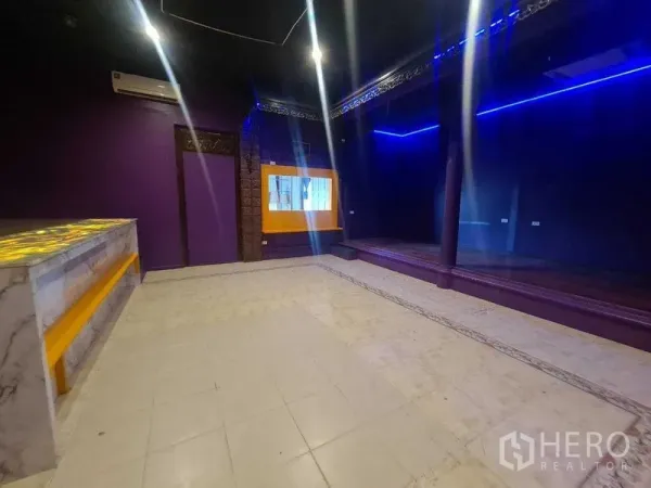 零售空间 出租在Watthana, Bangkok - 零售房间带镜面般的深色墙、平台舞台及黄色点缀窗户。