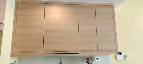 Condominium for rent or sale in Khlong Toei, Bangkok - Light wood overhead kitchen cabinets providing ample storage space.