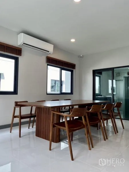 Detached House for rent in Bang Phli, Samut Prakan - Dining room from another angle showing sliding glass door and corner windows.