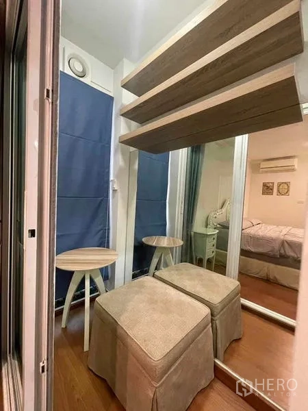 Condominium for rent - Compact dressing nook with stools, mirrored wardrobe and floating shelves.