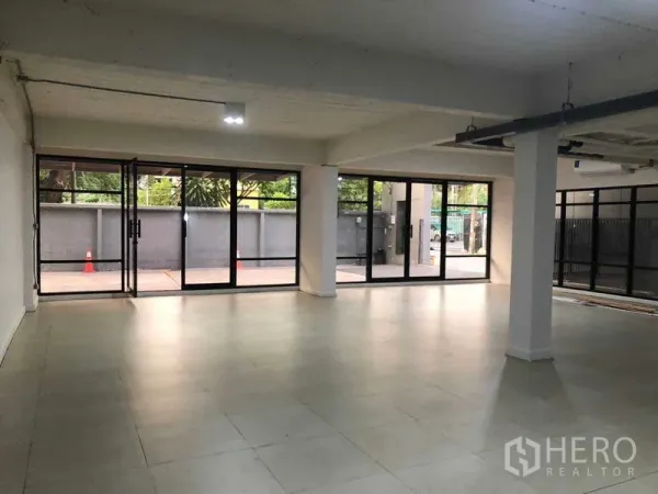Office Space for rent in Phaya Thai, Bangkok - Bright office space with floor-to-ceiling glass walls opening to a patio near BTS Saphan Khwai.