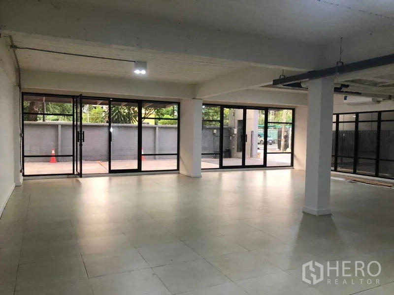 Office Space for rent in Phaya Thai, Bangkok - Bright office space with floor-to-ceiling glass walls opening to a patio near BTS Saphan Khwai.