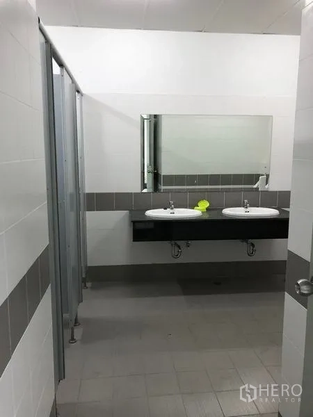 Warehouse for rent in Bang Phli, Samut Prakan - Clean staff restroom with twin basins, large mirror, and toilet cubicles.