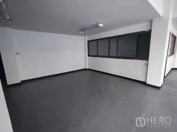 Warehouse for rent in Samut Sakhon - Separate office or meeting room with sliding windows and durable vinyl flooring.