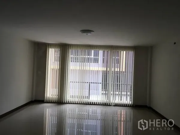 Home Office for rent in Lat Krabang, Bangkok - Spacious room with floor-to-ceiling windows and vertical blinds providing natural light.