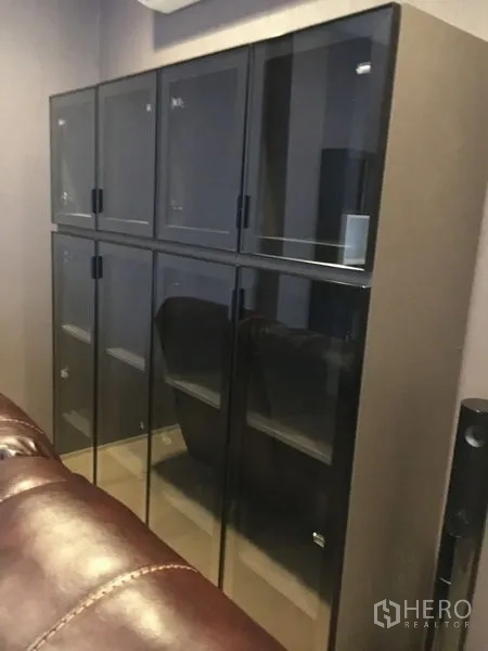 Detached House for rent in Wang Thonglang, Bangkok - Glass-front storage cabinet with multiple compartments in a media room.