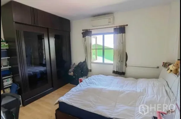独立式住宅 出售在Bang Yai, Nonthaburi - 带空调的卧室，大床与深色嵌入式衣柜