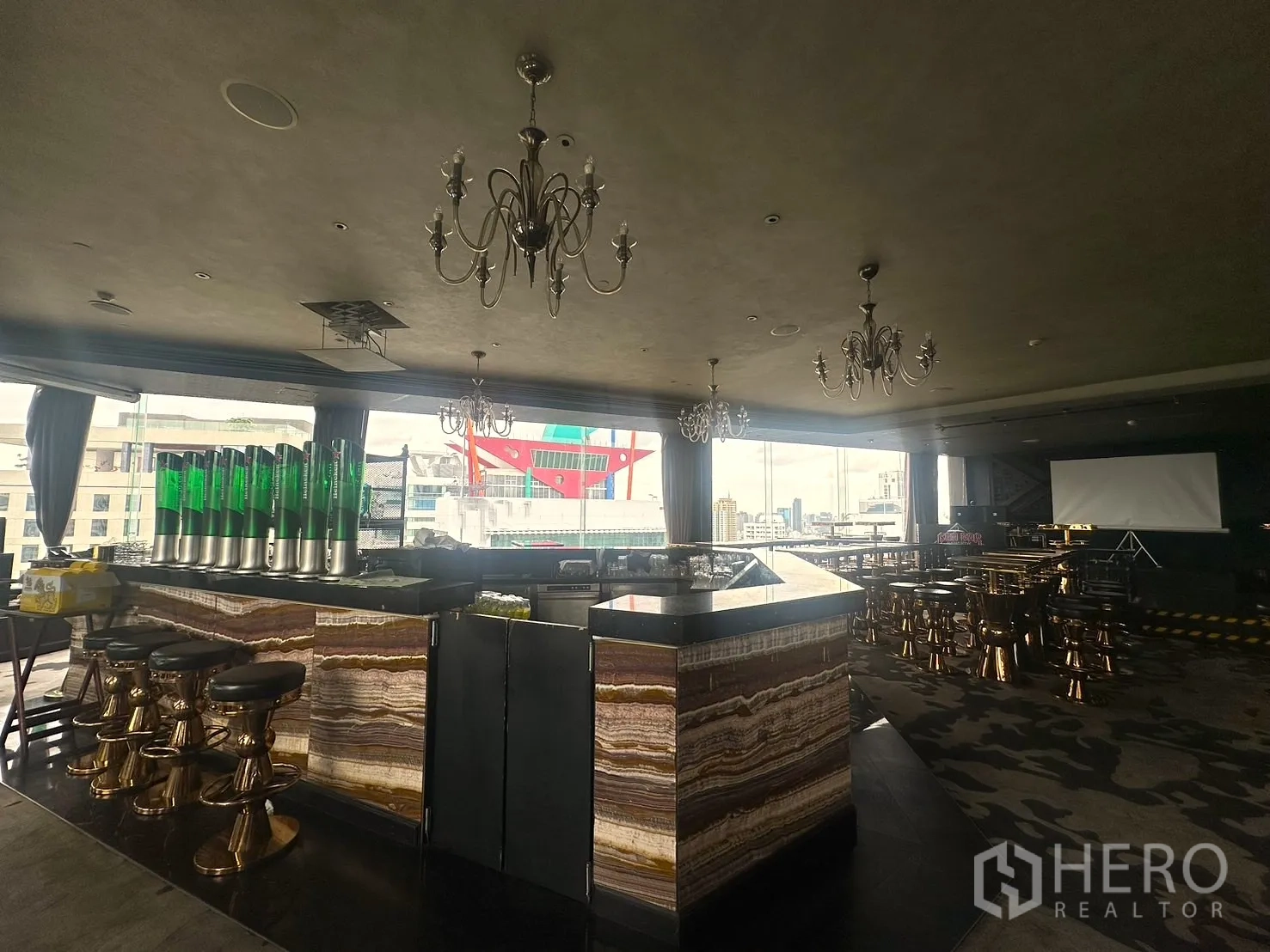 Retail Space for rent in Khlong Toei, Bangkok - Main marble-topped bar with chandeliers and high stools in a spacious hall.