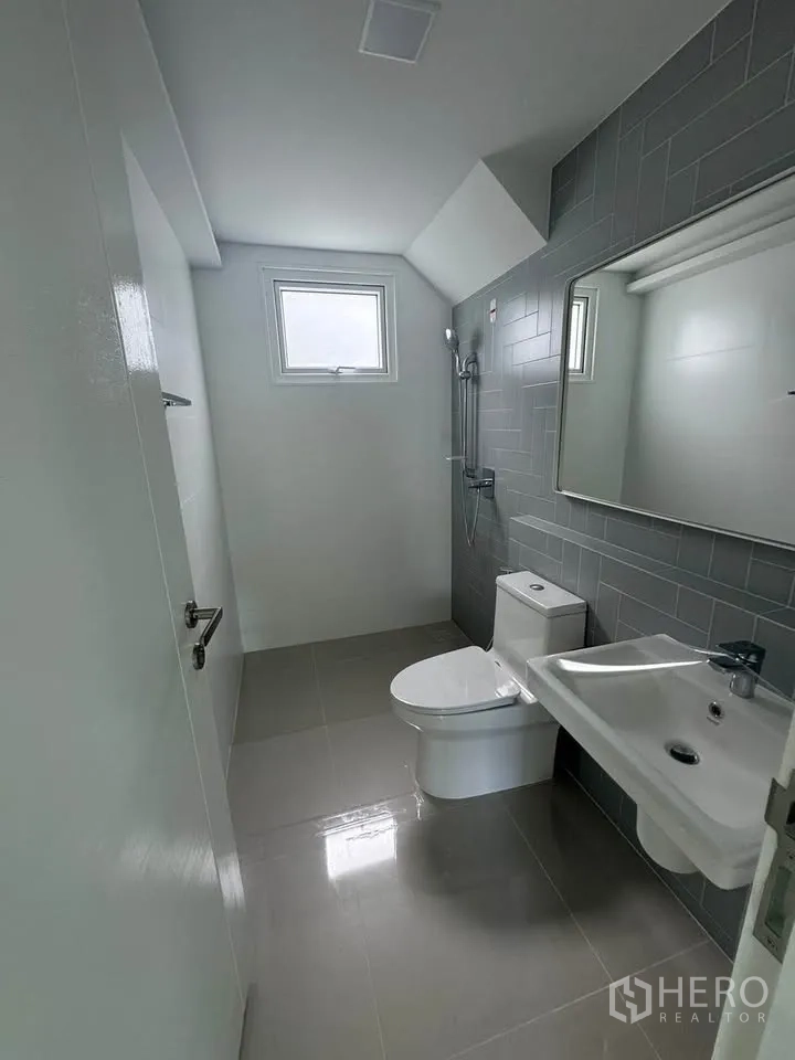 Detached House for rent in Bang Phli, Samut Prakan - Second bathroom with window, gray tiled wall, and walk-in shower.