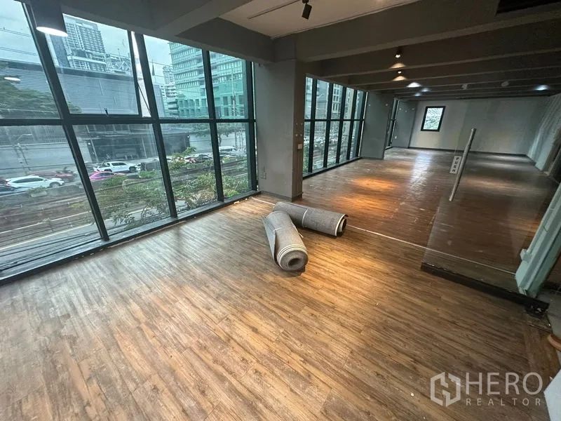 Office Space for rent in Bang Rak, Bangkok - Bright open office with panoramic glazing overlooking the city and rolled carpets on the floor.