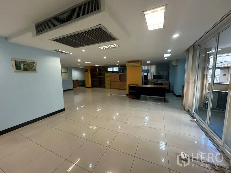 Office Space for sale - Open office featuring ceiling cassette air conditioner and full-height glass doors.