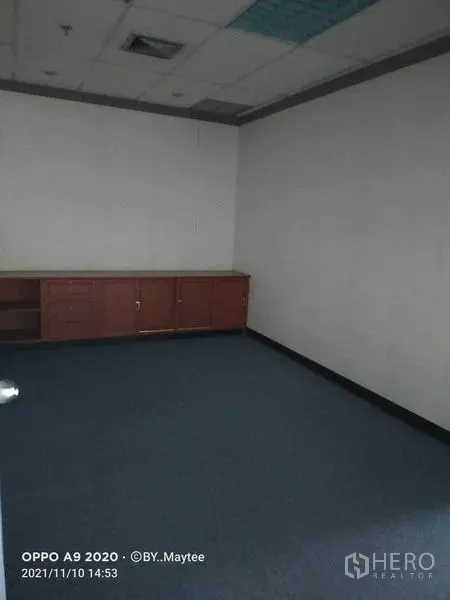 Office Space for rent in Watthana, Bangkok - Internal room with blue carpet, suspended ceiling and low built-in storage cabinets, suitable for meeting or storage.