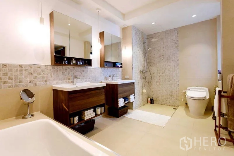 Home Office for sale in Watthana, Bangkok - Contemporary bathroom with double vanities, walk-in shower and bathtub edge in view.