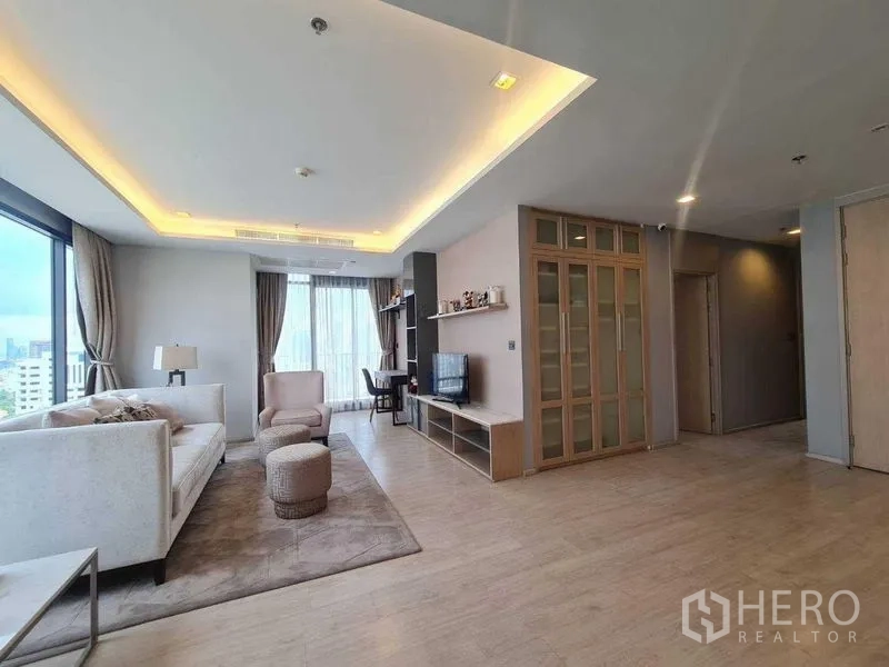 Condominium for sale - Bright living room with cove lighting, sofa set, TV unit and built-in shelves.
