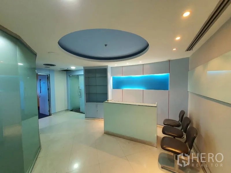 Office Space for rent in Watthana, Bangkok - Reception area with counter, display shelving and visitor seating beside glass partitions.