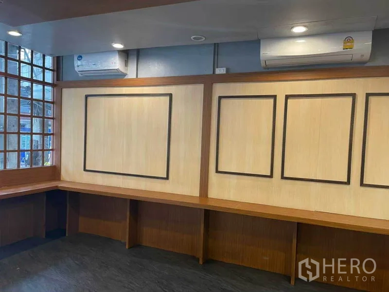 Retail Space for rent in Watthana, Bangkok - Wall-length built-in bench with paneled feature wall, recessed lighting and dual air-conditioning units.