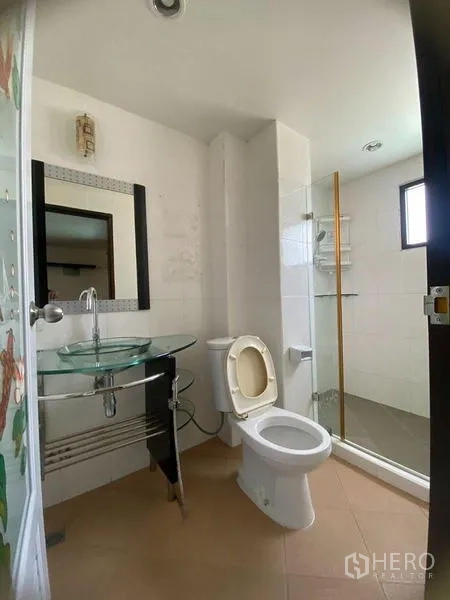 Home Office for rent in Don Mueang, Bangkok - Second bathroom with glass sink, toilet and shower stall.