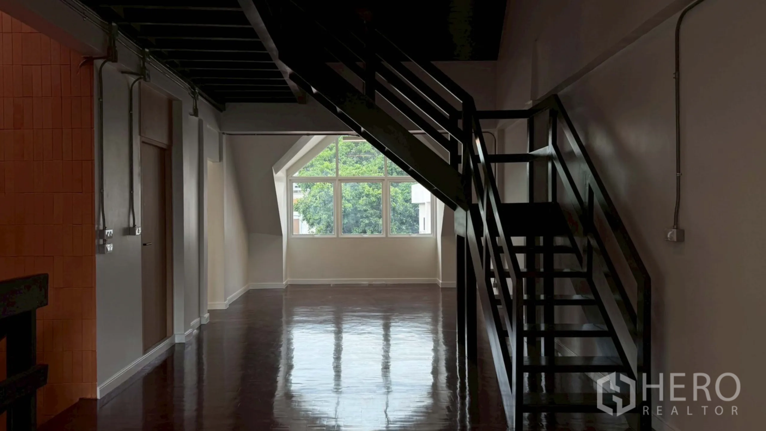 Home Office for rent in Watthana, Bangkok - Spacious top floor with central staircase and gable window view.