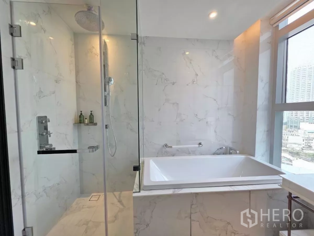 Condominium for rent - Hallway leading to open kitchen with marble island and recessed lighting.