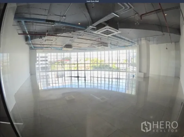 Office Space for rent in Khlong Toei, Bangkok - Bright office interior featuring grid windows, cassette air-conditioning, and visible piping for an industrial look.