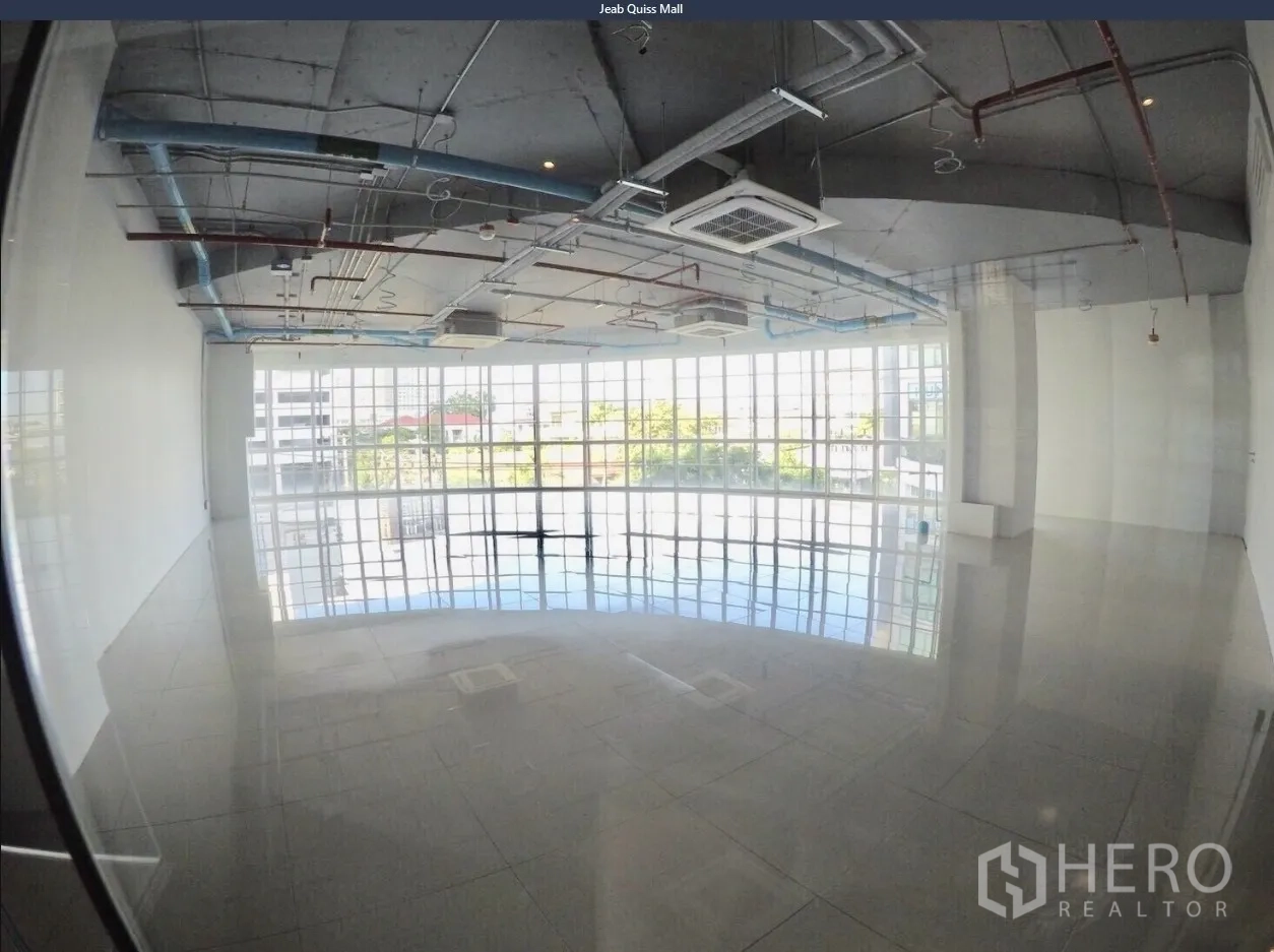 Office Space for rent in Khlong Toei, Bangkok - Bright office interior featuring grid windows, cassette air-conditioning, and visible piping for an industrial look.