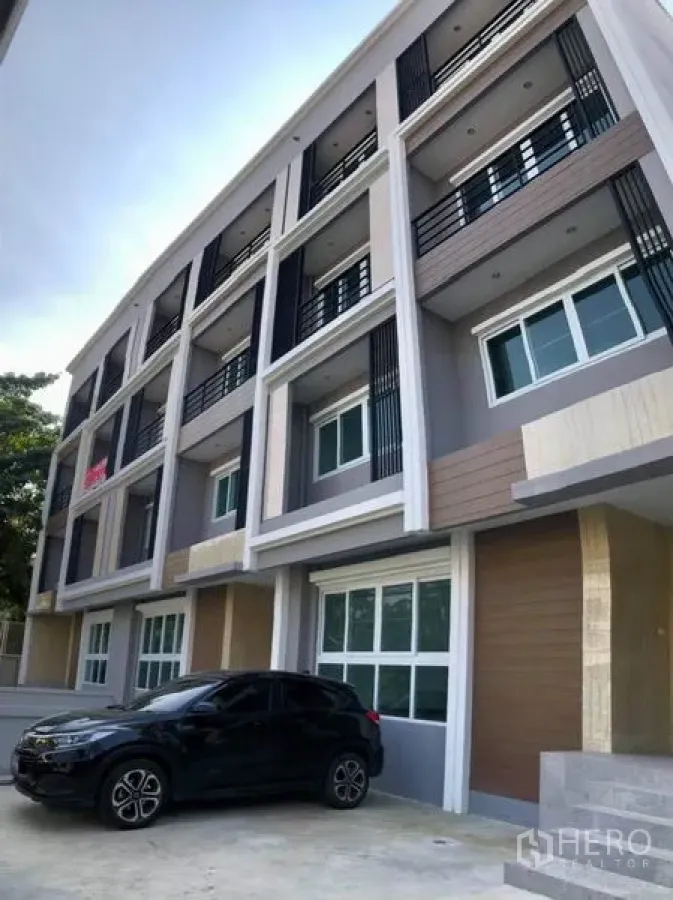 Home Office for rent in Prawet, Bangkok - Modern multi-storey home office exterior with balconies and ground-level parking area.