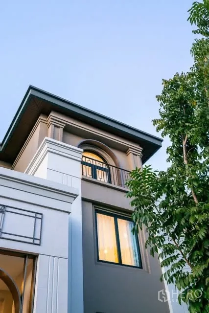 Detached House for rent or sale in Saphan Sung, Bangkok - Close-up of the house exterior showing arched balcony and windows.