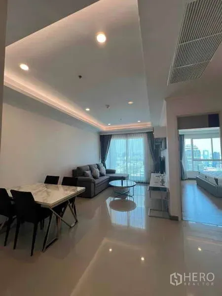 Condominium for rent in Ratchathewi, Bangkok - Bright open living space leading to bedroom with glossy floors.
