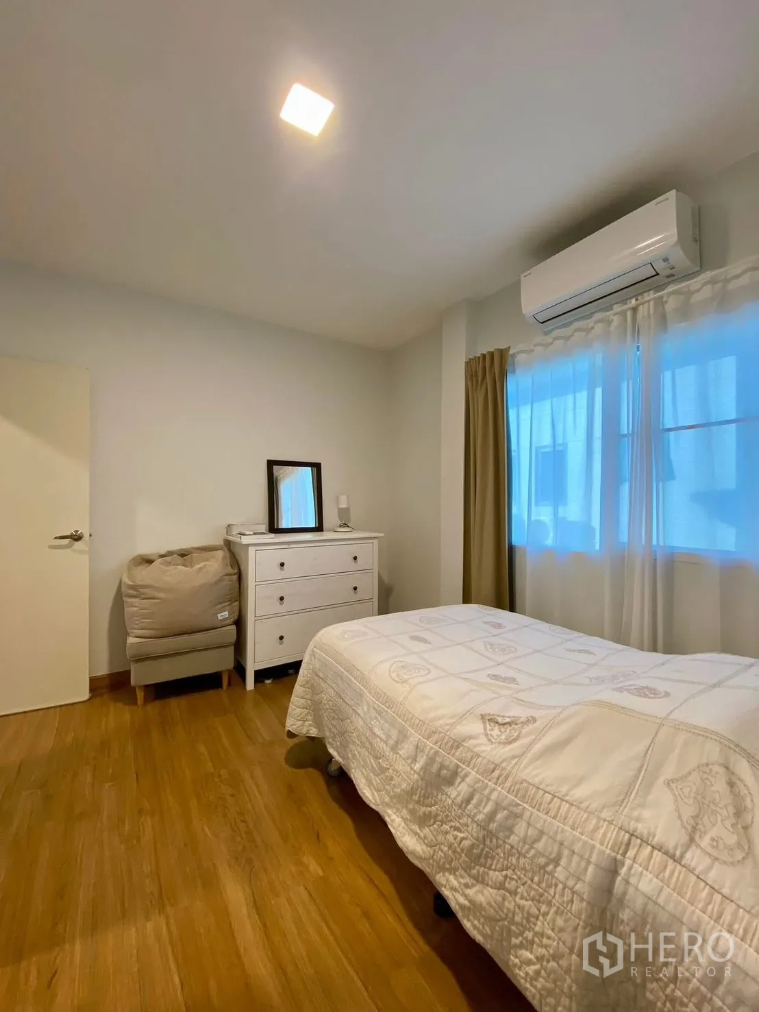 Semi-detached House for rent in Bang Phli, Samut Prakan - Bedroom view with dresser, AC unit and soft curtains.