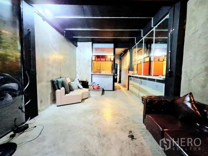 店屋 出租在Bang Rak, Bangkok - 工业风起居区，面向吧台与后走廊，水泥质感明显。