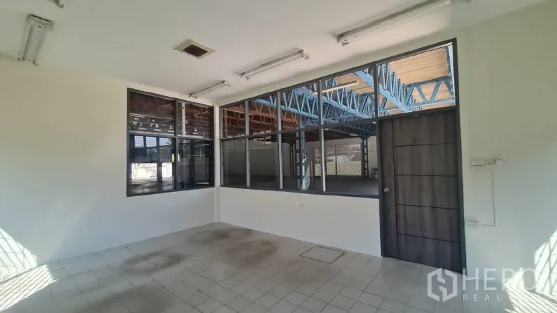 Warehouse for rent in Khlong Toei, Bangkok - Office interior looking toward the warehouse through large windows.