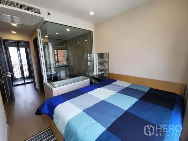 Condominium for rent or sale in Watthana, Bangkok - Master bedroom featuring a glass‑walled en‑suite bathroom with bathtub.