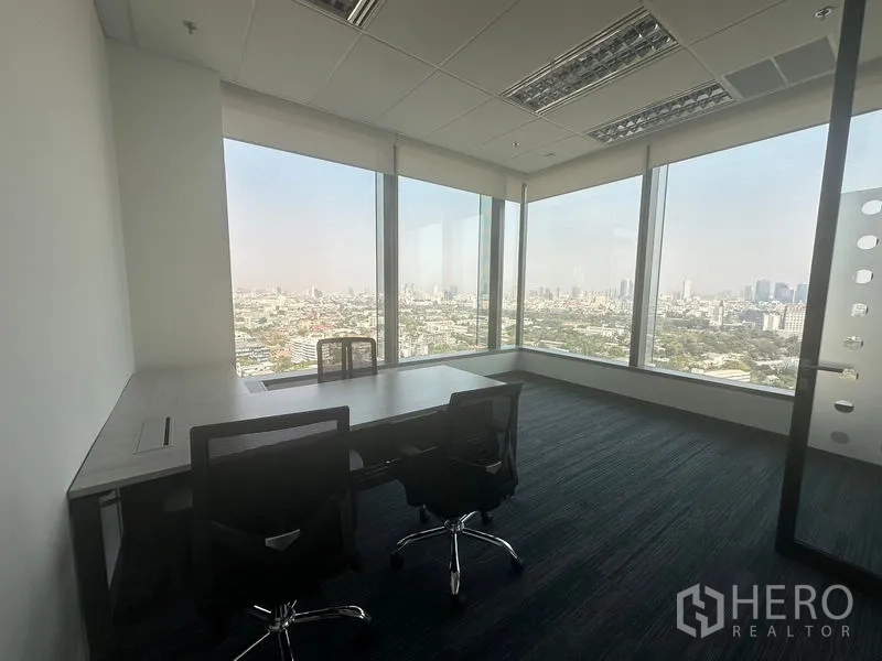 Office Space for rent in Ratchathewi, Bangkok - Private corner office with large windows and two desks.