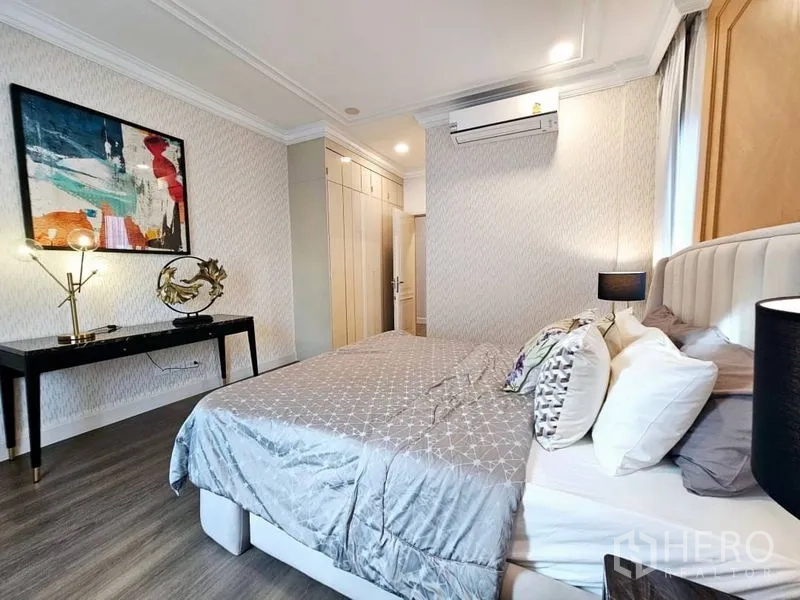 Detached House for rent or sale in Saphan Sung, Bangkok - Guest bedroom with artwork, built‑in wardrobe and writing desk.