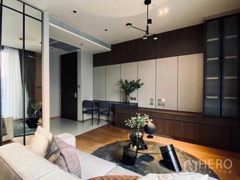 Condominium for rent or sale - Contemporary lounge with built-in cabinetry and round glass coffee table.