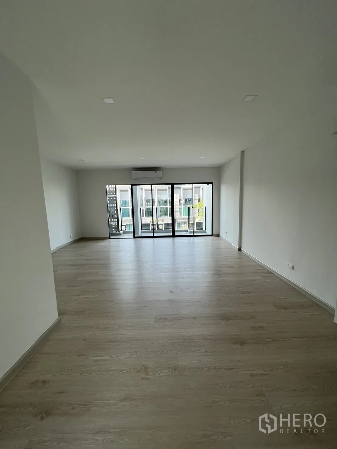 Home Office for rent in Bang Phli, Samut Prakan - Large multipurpose room with sliding doors opening to a balcony and AC unit.