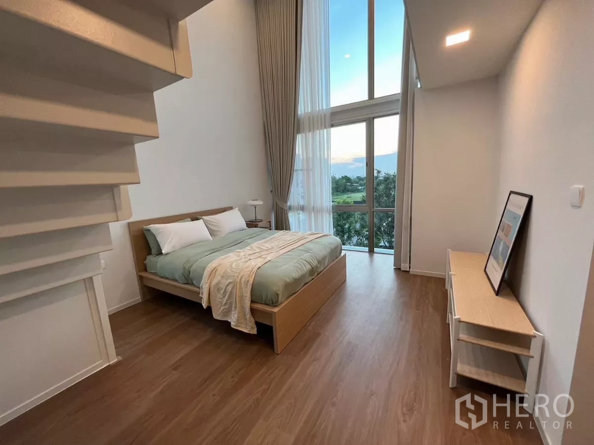 Detached House for rent in Saphan Sung, Bangkok - Second terrace with two chairs and greenery views behind a glass railing.