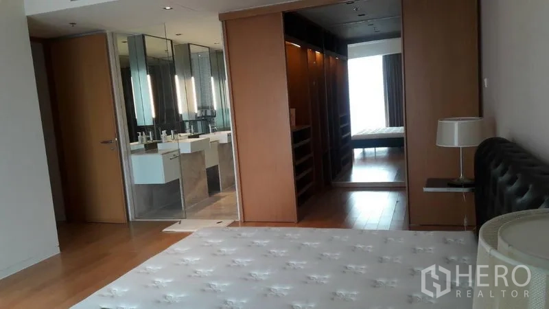 Condominium for sale in Sathon, Bangkok - Spacious master suite showing bed, walk-in closet and ensuite bathroom.